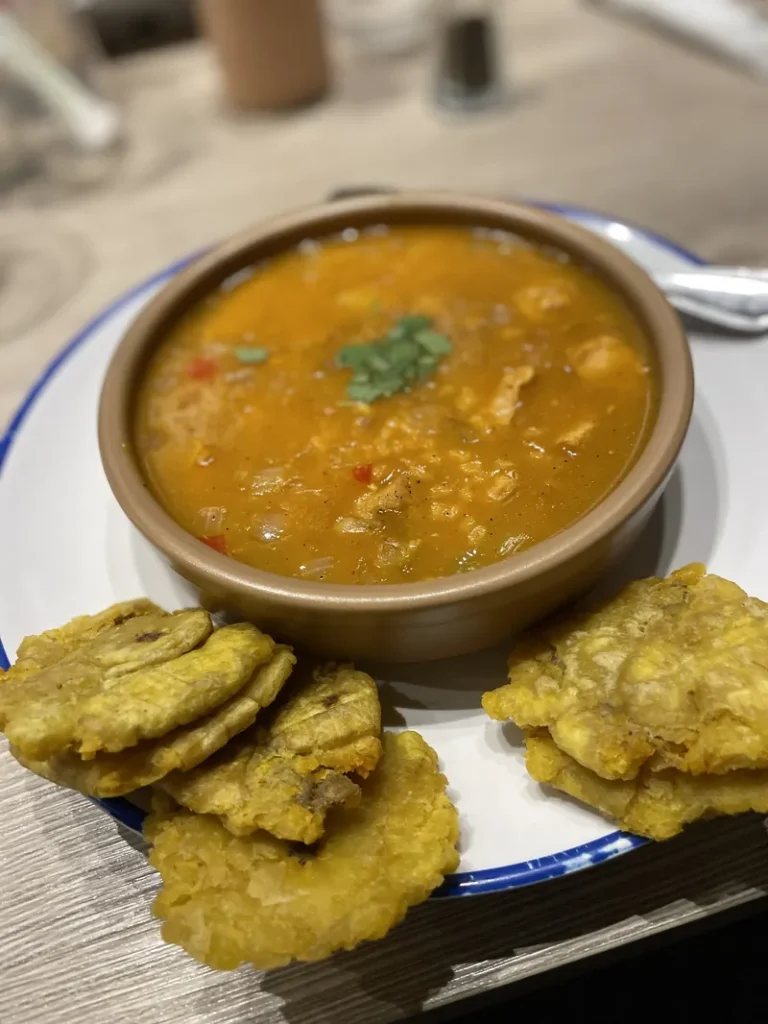 Traditional Puerto Rican sancocho stew prepared during cooking class at Root to Rise Retreat