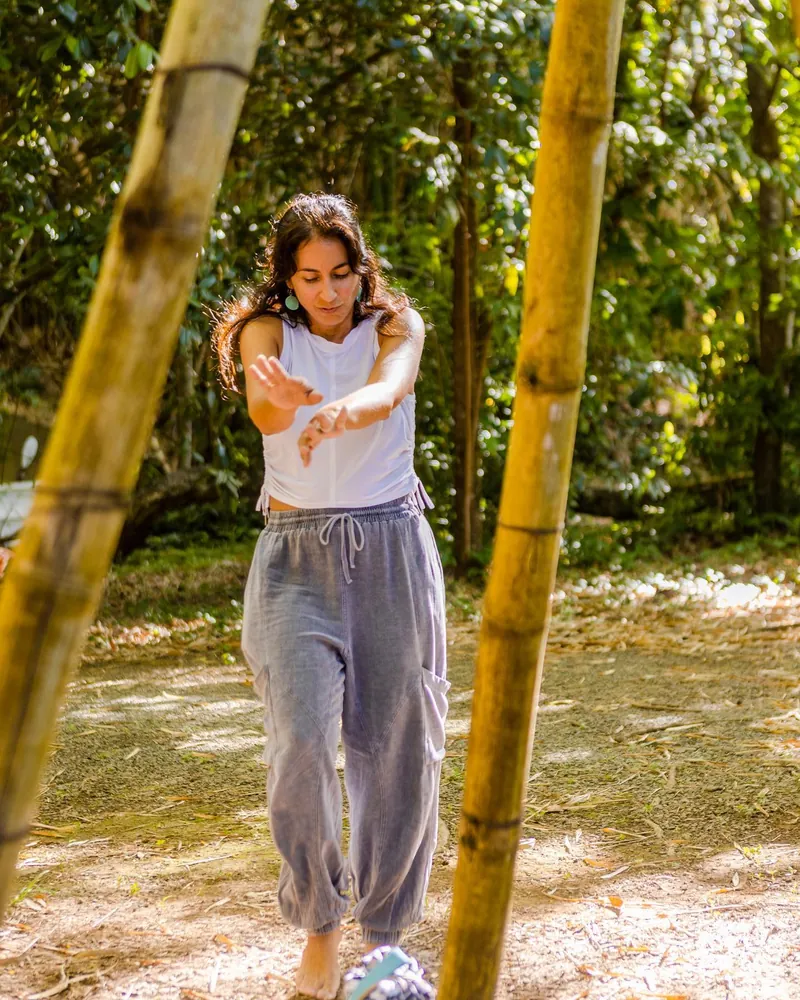 Woman practicing mindfulness among bamboo trees at Dos Aguas Retreat