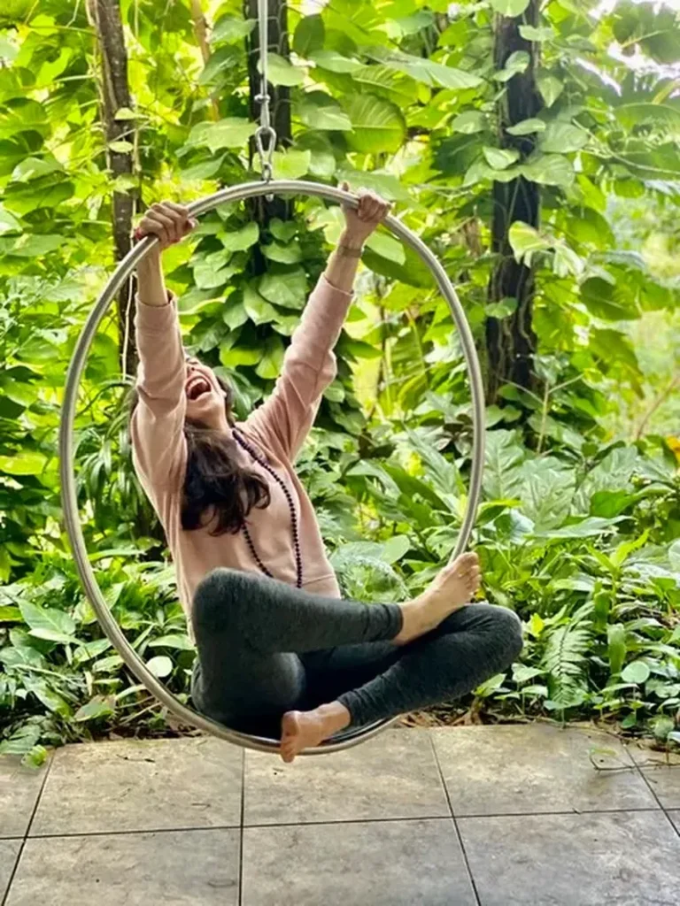 Woman practicing aerial hoop movement at Root to Rise Retreat in Puerto Rico