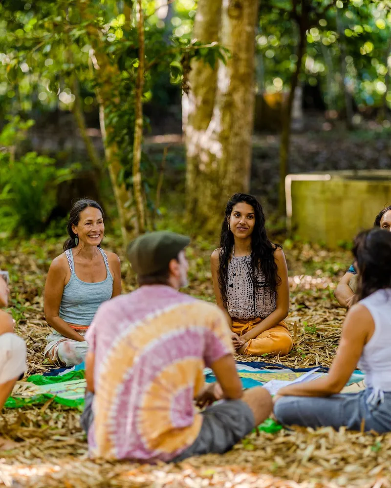 Small group discussion in nature during Root to Rise Retreat at Dos Aguas
