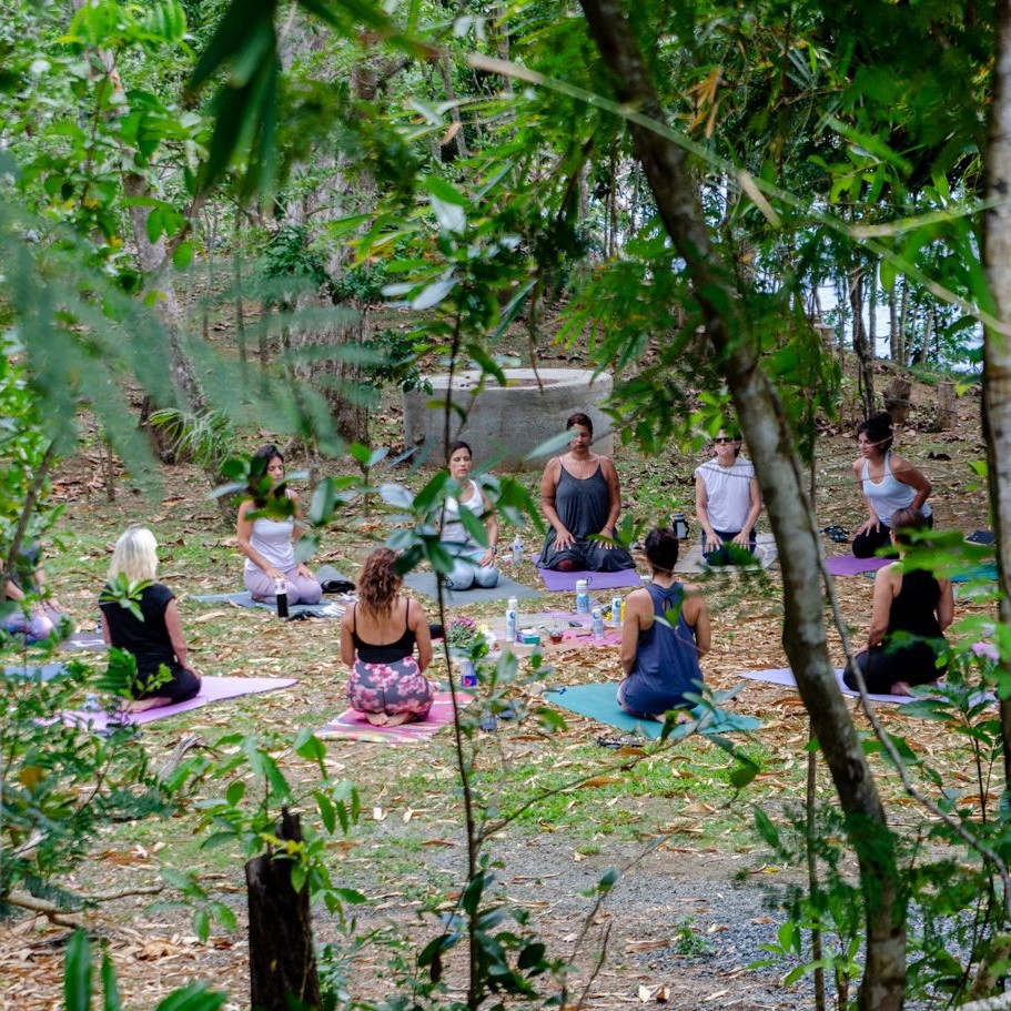 Retreat group gathered for for morning yoga at Dos Aguas during the Root to Rise Retreat in Puerto Rico