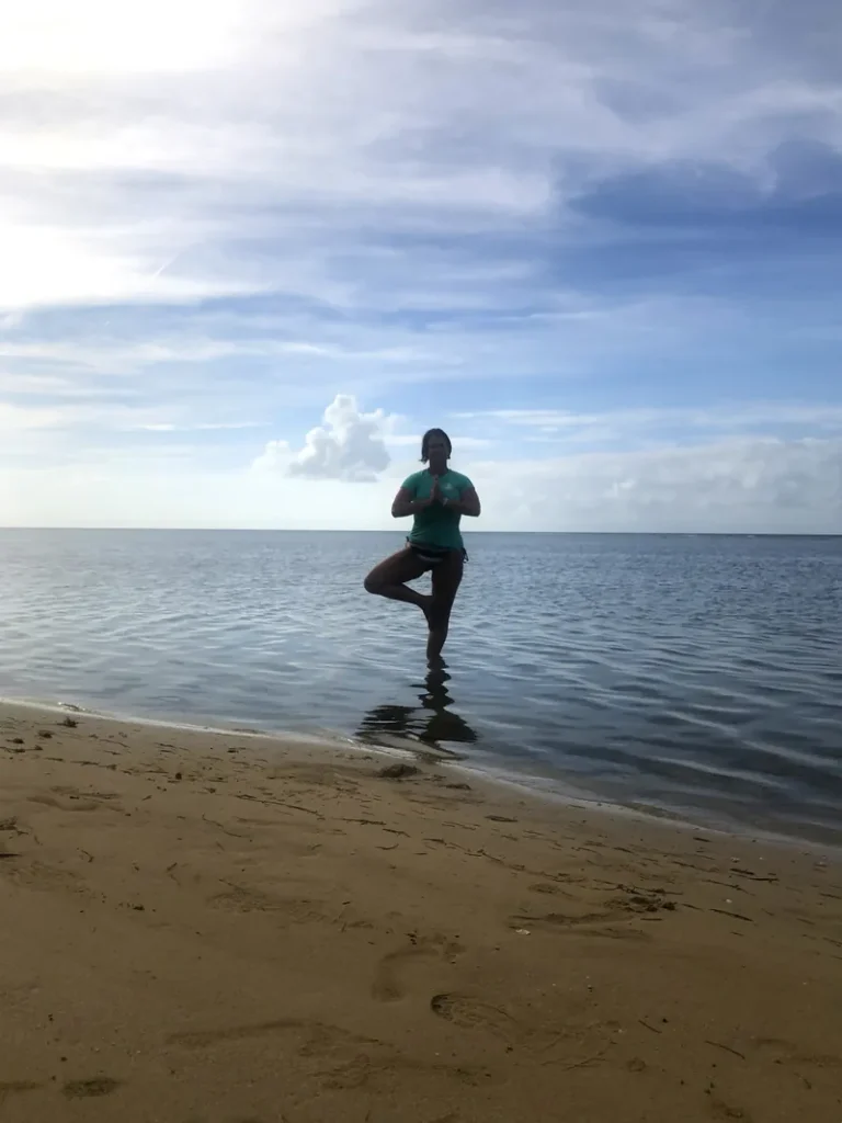 Yoga practice on the beach at sunrise in Puerto Rico during the Root to Rise Retreat