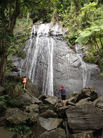 Group hiking to a rainforest la coca falls in El Yunque Puerto Rico during the Root to Rise Retreat